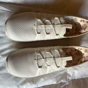 Skechers Women's Slip-On Athletic Sneakers in White with Floral Insole